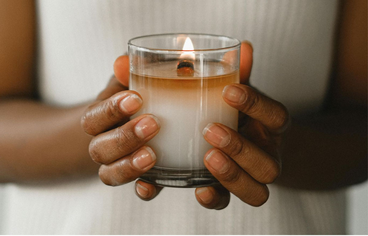Person practicing meditation holding a candle